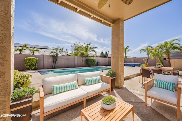 view of patio featuring a fenced in pool, outdoor dining area, outdoor lounge area, a ceiling fan, and a fenced backyard