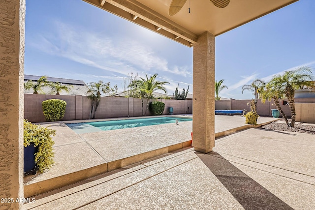 view of pool with a fenced backyard, ceiling fan, a fenced in pool, and a patio