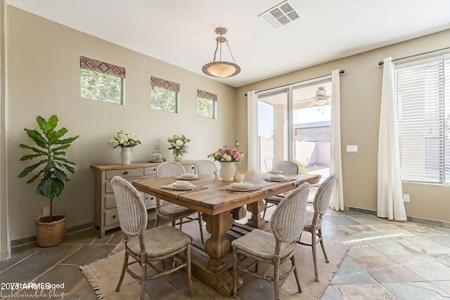 dining area with plenty of natural light, visible vents, and baseboards