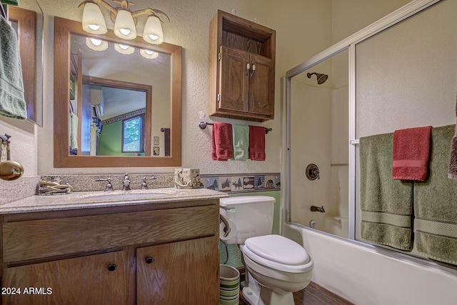 full bathroom featuring enclosed tub / shower combo, oversized vanity, and toilet