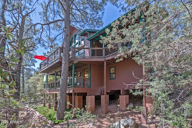 view of side of home with a balcony