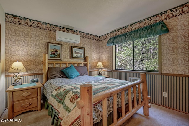 bedroom with a wall mounted AC and carpet floors