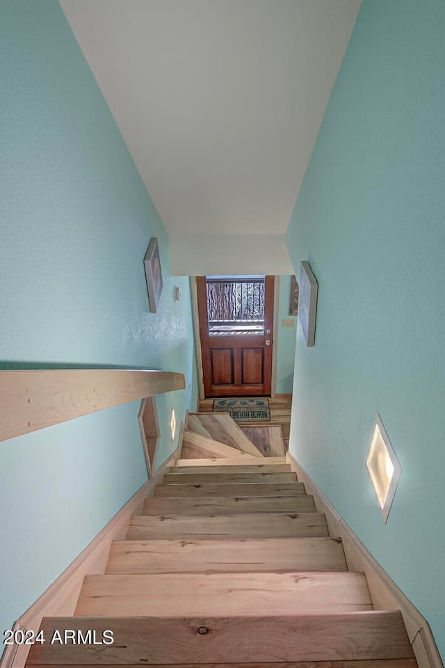 stairway with hardwood / wood-style flooring