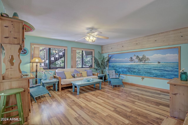 living room featuring ceiling fan and hardwood / wood-style floors