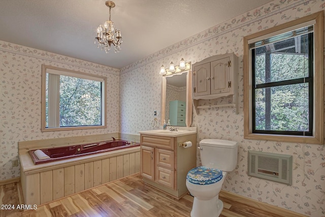 bathroom with a bath, wood-type flooring, vanity, and toilet