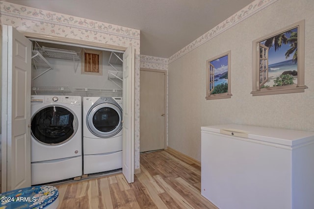 washroom featuring separate washer and dryer and light wood-type flooring