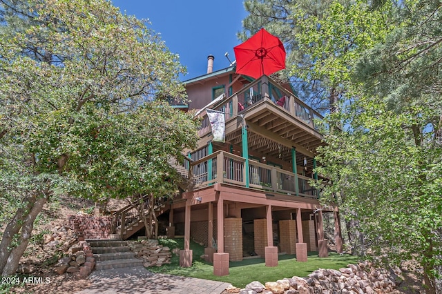 back of house featuring a deck and a yard