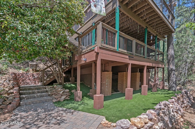 view of property exterior with a lawn, a patio area, and a wooden deck