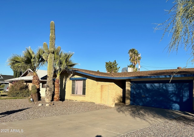 view of front of home with an attached garage and concrete driveway