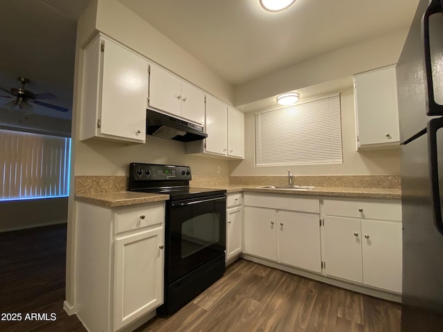 kitchen featuring light countertops, white cabinets, a sink, black range with electric cooktop, and under cabinet range hood