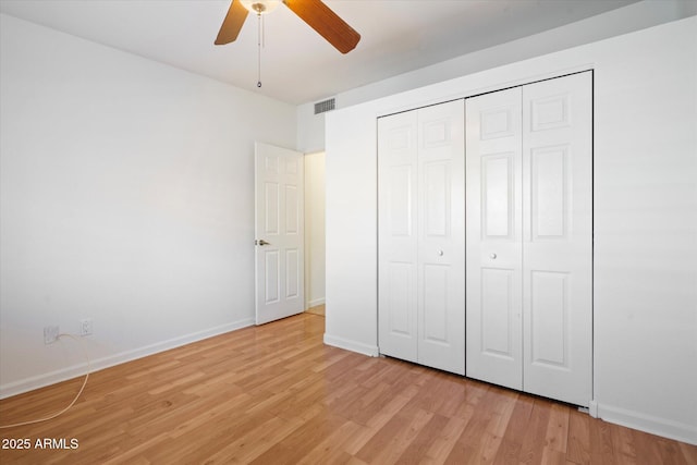 unfurnished bedroom with ceiling fan, light hardwood / wood-style floors, and a closet