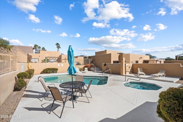 view of swimming pool featuring a community hot tub and a patio