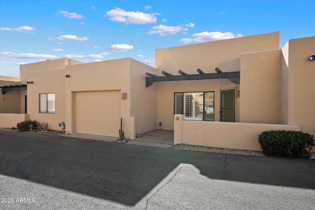 pueblo-style home featuring a garage