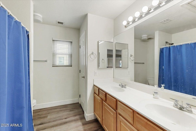 462 W Myrtle Dr, Chandler, AZ 85248 - bathroom featuring toilet, wood finished floors, double vanity, baseboards, and a shower with curtain