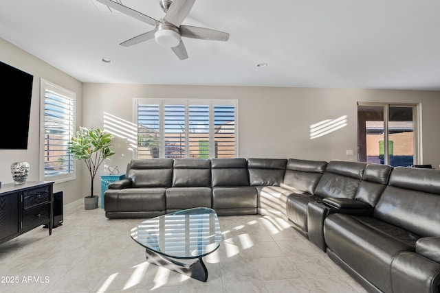 living room featuring light tile patterned floors and ceiling fan