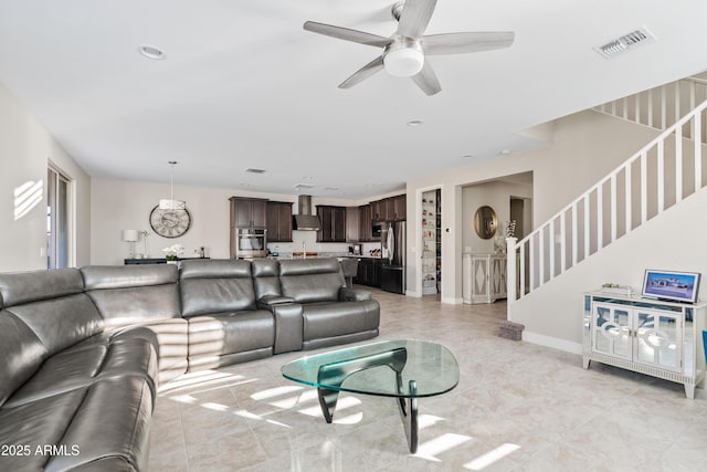 living room with light tile patterned floors and ceiling fan