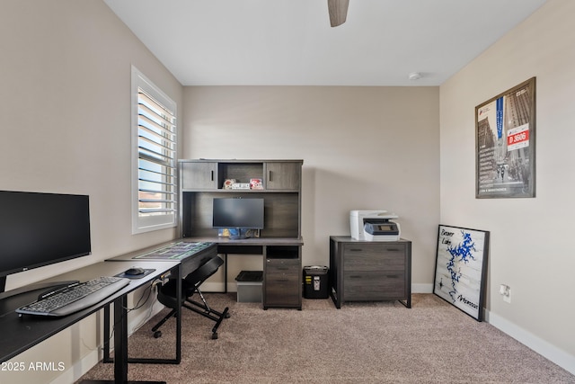 office area featuring light carpet and ceiling fan