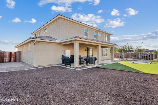 back of property with a patio