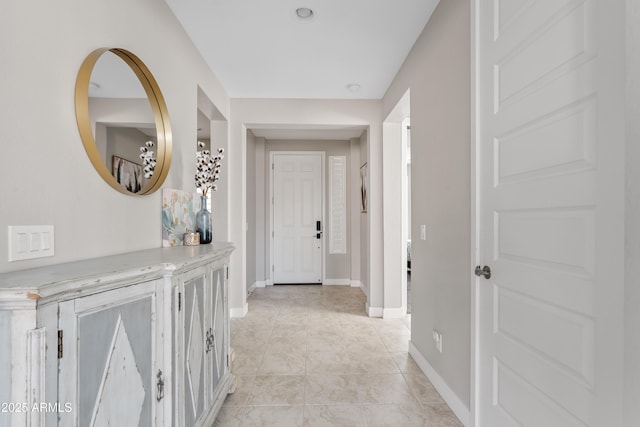 hall featuring light tile patterned flooring