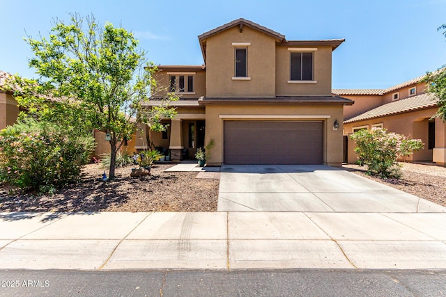 traditional-style home with stucco siding, an attached garage, and driveway