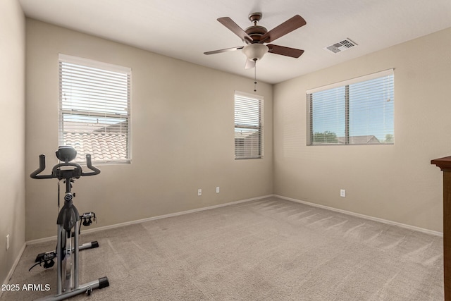 workout room with visible vents, baseboards, ceiling fan, and a wealth of natural light