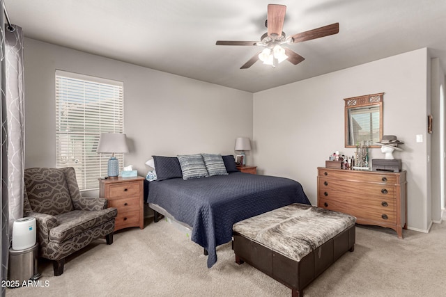 bedroom featuring a ceiling fan and light colored carpet