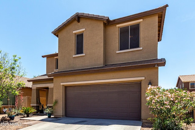 traditional-style home featuring an attached garage, driveway, and stucco siding