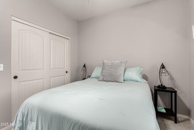 bedroom featuring a closet, carpet flooring, and baseboards