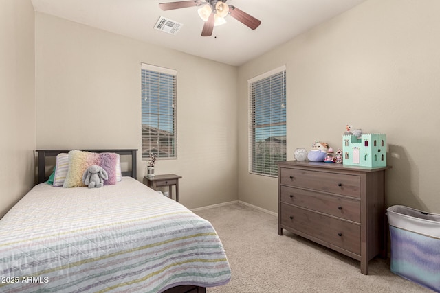 bedroom featuring visible vents, a ceiling fan, baseboards, and light colored carpet