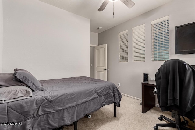 bedroom featuring ceiling fan and light carpet