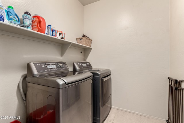 laundry area with laundry area, baseboards, light tile patterned flooring, and separate washer and dryer