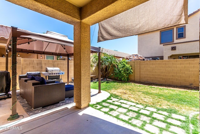 exterior space with a gazebo, outdoor lounge area, a fenced backyard, and a patio area