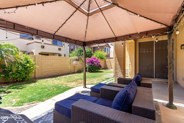 view of patio / terrace featuring an outdoor living space, fence, and a gazebo