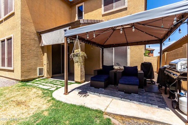 view of patio with a gazebo and fence