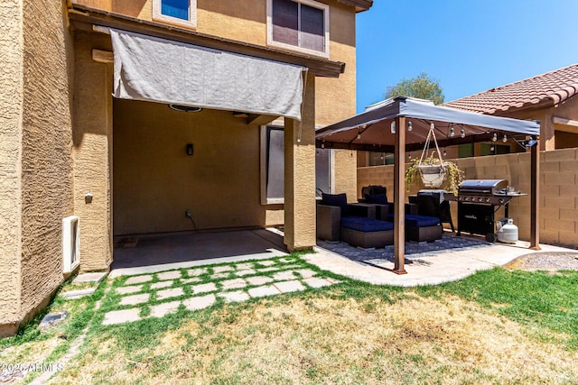 rear view of house featuring fence, outdoor lounge area, a patio area, and stucco siding