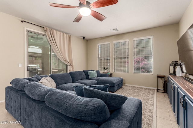 living area with a ceiling fan, baseboards, visible vents, and light tile patterned flooring