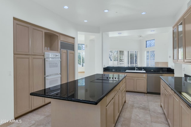 kitchen with kitchen peninsula, black electric stovetop, stainless steel dishwasher, double oven, and a center island