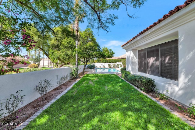 view of yard with a fenced in pool