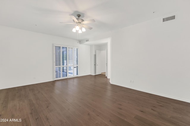 spare room featuring ceiling fan and dark wood-type flooring