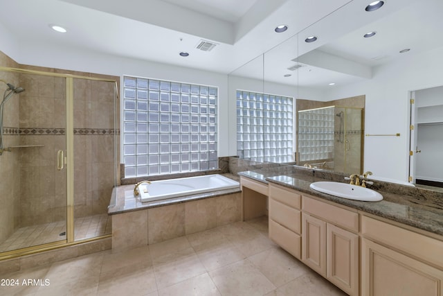 bathroom featuring vanity and independent shower and bath