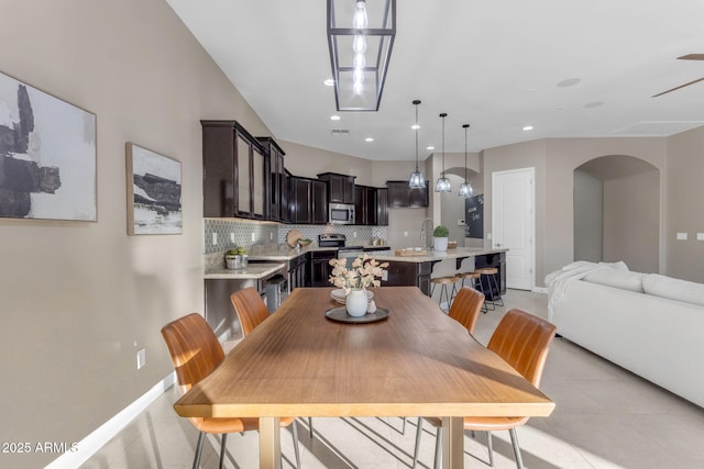 dining room with ceiling fan and sink