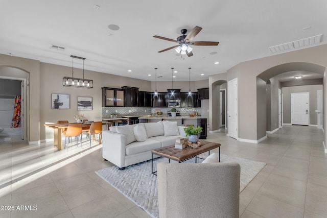 living room with ceiling fan and light tile patterned floors