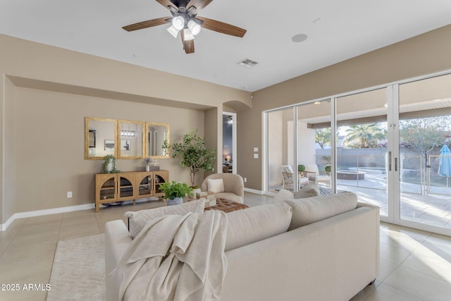 living room featuring light tile patterned floors and ceiling fan