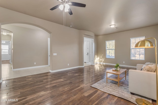 living room featuring dark hardwood / wood-style floors and ceiling fan