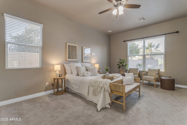 bedroom with ceiling fan and light carpet