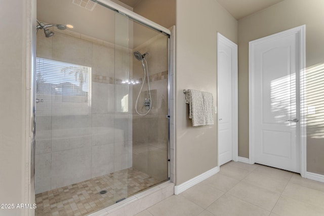 bathroom with tile patterned floors and walk in shower