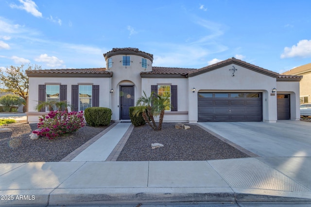 mediterranean / spanish home with a garage