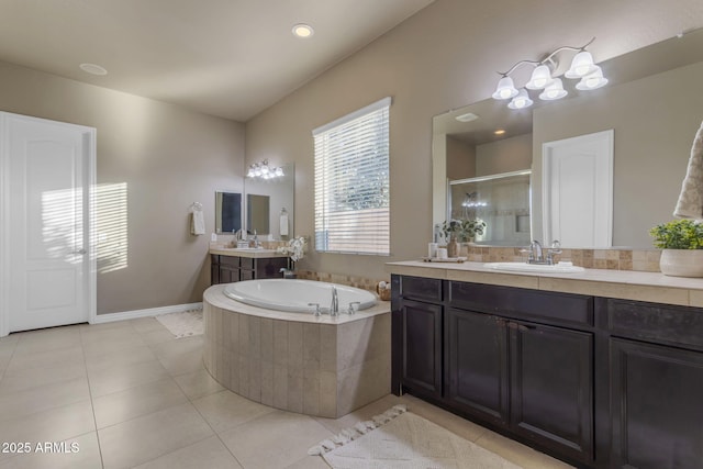 bathroom featuring tile patterned floors, vanity, and separate shower and tub