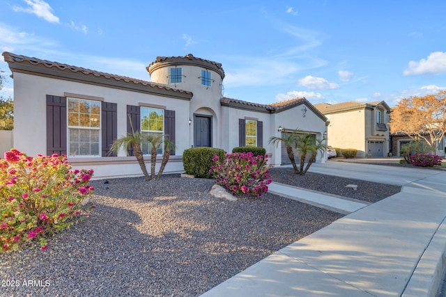 mediterranean / spanish house featuring a garage