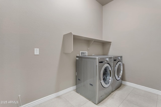 laundry room featuring light tile patterned flooring and separate washer and dryer